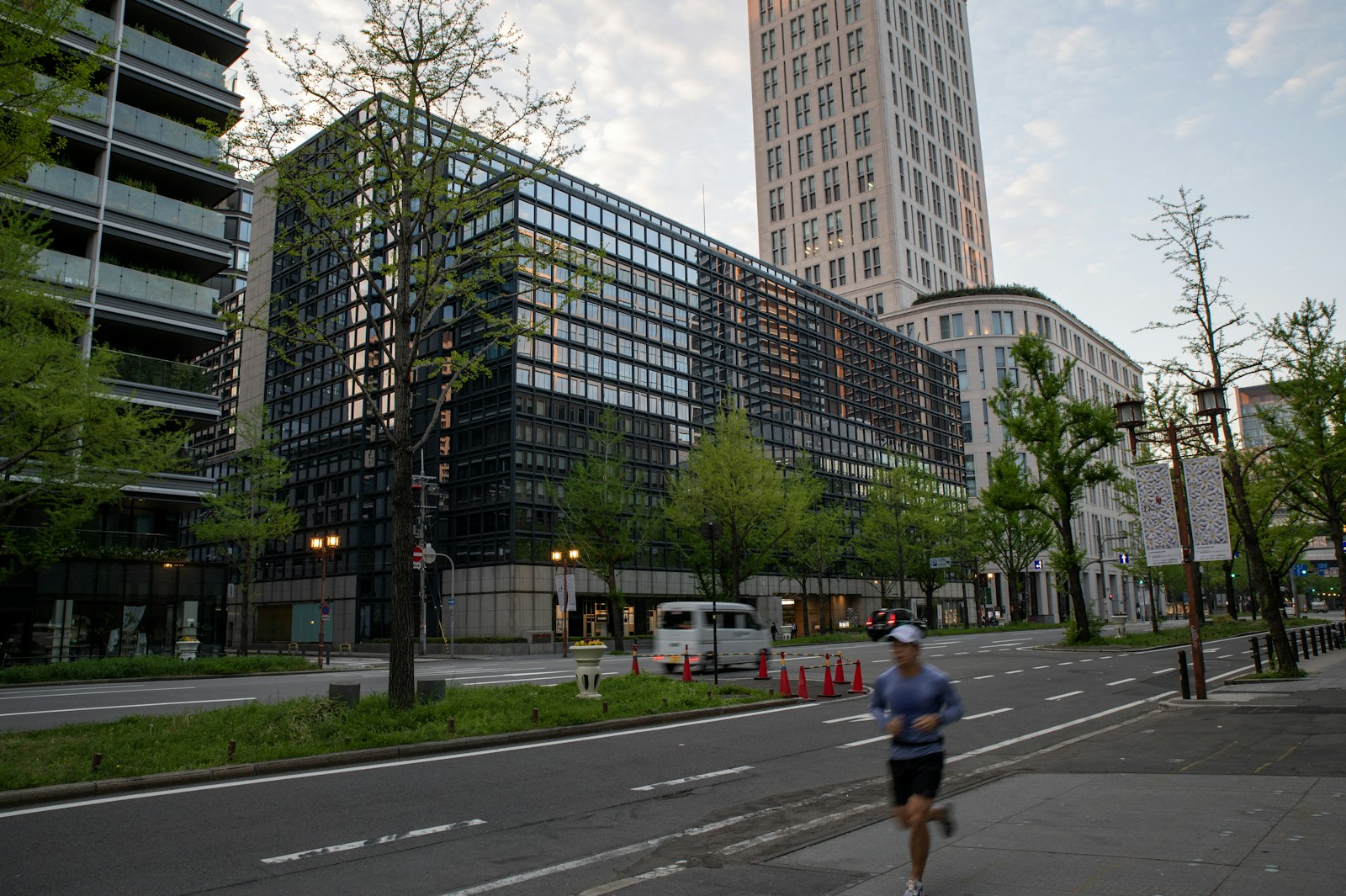 Runner on the sidewalk along the city street