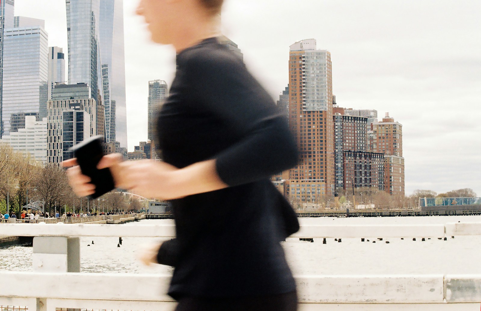 Runner with a phone in hand in the city
